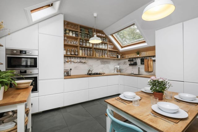 The kitchen, which has ample dining space, has been designed to utilise the space perfectly with a fantastic range of white modern units, contrasting wooden worktop and shelving. integrated oven and microwave, integrated washing machine, fridge freezer and dish washer.