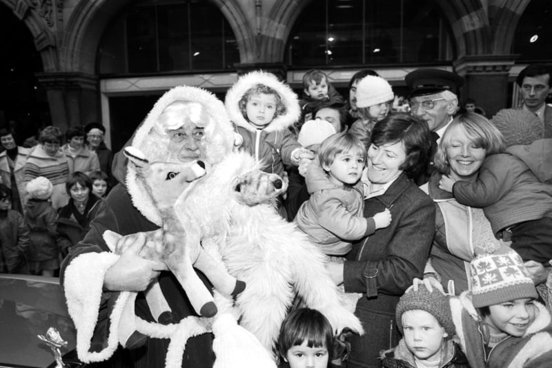 The Jenners Santa Claus arrives at the Edinburgh department store to be met by parents and children in November 1980.