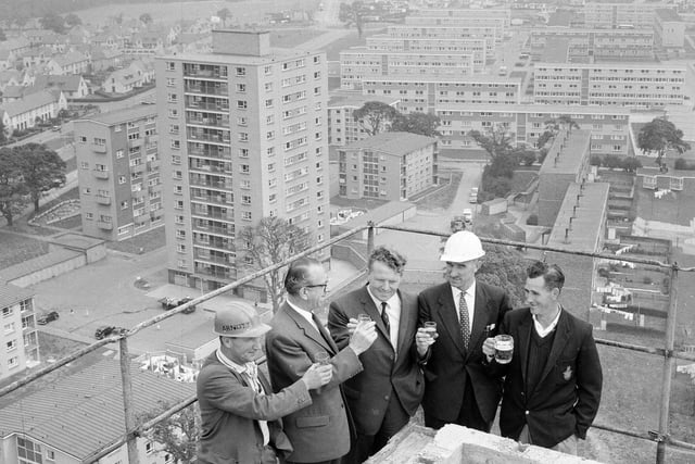 The Muirhouse Flats topping out ceremony (right-left) T. Kelly (ganger), A.McLeod of William Arnott McLeod Ltd, Councillor Pat Rogan, R. Mackie (head foreman) and R.Williams (joiner) in August 1964.