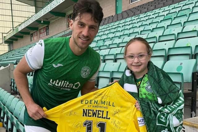 Orla with Hibs player Joe Newell at Easter Road.