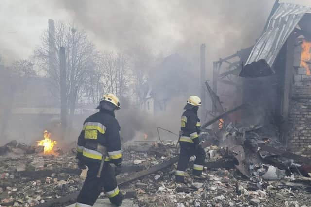 This handout picture released by the State Emergency Service of Ukraine on March 11, 2022, shows rescuers working at the scene of an airstrike in Dnipro.Photo by Handout / State Emergency Service of Ukraine / AFP