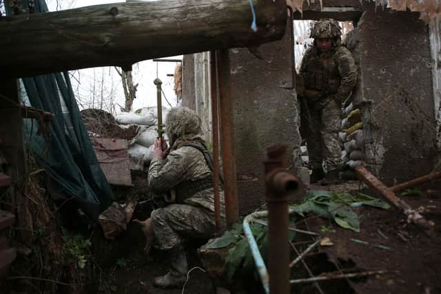 Ukrainian soldiers keep watch on the frontline with Russia-backed separatists, not far from town of Avdiivka, Donetsk, on Friday (Picture: Anatolii Stepanov/AFP via Getty Images)