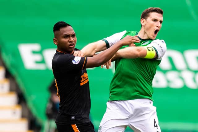 Paul Hanlon and Alfredo Morelos come toether during the match at Easter Road