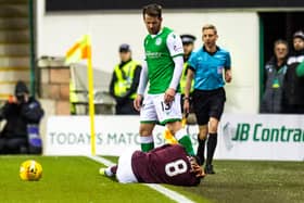 Hearts midfielder Sean Clare is grounded after a challenge from Hibs' Marc McNulty