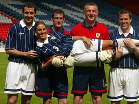 Julie Fleeting modelling a new strip with David Weir, Paul Gallacher, Robert Douglas and Gary Caldwell in May 2002. A chauvinistic picture that would not be considered appropriate nowadays.