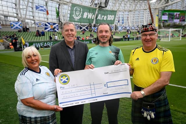 Ireland World Cup hero Pat Bonner with Neil Forbes and Diane Doig of the Tartan Army Sunshine Appeal as Kerrie Clohessy from SARI receives their cheque.