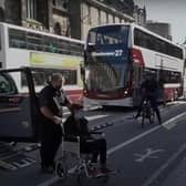 A taxi driver and wheelchair user attempt to negotiate the new road layout