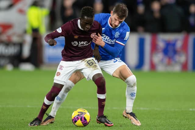 Karang Kuol tries to hold off Rangers full-back Borna Barisic. It was a baptism of fire for the youngster in midfield. Picture: Mark Scates / SNS