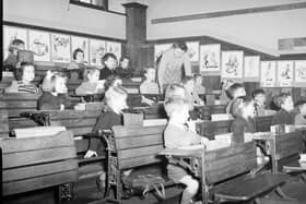 Children sit in a tiered or "galleried" classroom at South Morningside School in the 1950s.