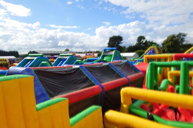 A colourful photo of the obstacle course taken from the top of one of the climbing obstacles half way through the Tartan Titan.