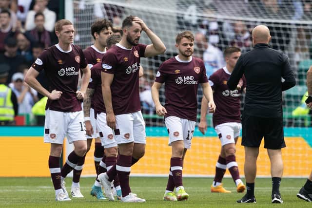 A stunned Craig Halkett leads the Hearts players off the field after conceding a late equaliser to rivals Hibs at Easter Road. Picture: SNS