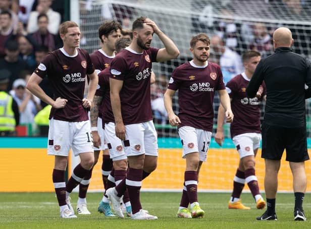 A stunned Craig Halkett leads the Hearts players off the field after conceding a late equaliser to rivals Hibs at Easter Road. Picture: SNS