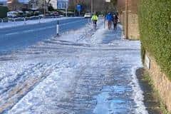 A cyclist battles with the icy surface in the cycle lane on Comiston Road