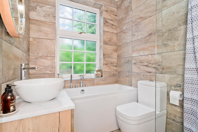 This bright and good-sized family bathroom has been modernised.