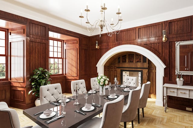 The wood-panelled dining room where there is a magnificent fireplace with an intricately carved wood inscription.