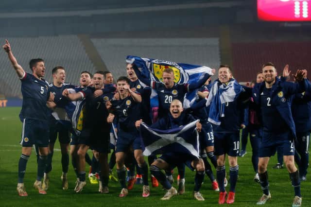 The Scotland players celebrate their Euros playoff triumph, just before getting stuck into Yes Sir, I Can Boogie (Picture: Srdjan Stevanovic/Getty Images)