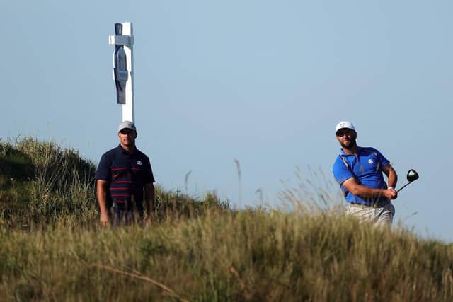 Bryson DeChambeau looks on as Jon Rahm plays his shot from the 14th tee. Picture: Stacy Revere/Getty Images.