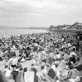 Crowds of holidaymakers on Portobello Beach in May 1952 with the rollercoaster and funfair in the background.