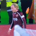 Hearts winger Barrie McKay is struck by a plastic bottle thrown from the Celtic support.