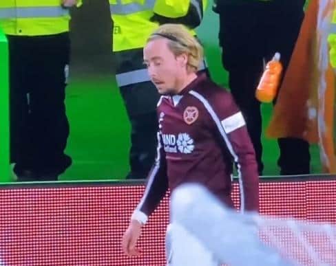 Hearts winger Barrie McKay is struck by a plastic bottle thrown from the Celtic support.