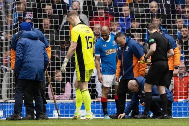 The start of the second half at Ibrox was  delayed as broken glass is removed from Celtic 'keeper Joe Hart's goal.  (Photo by Craig Williamson / SNS Group)