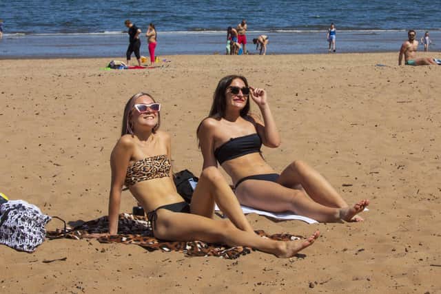 Summer is forecast to arrive in Edinburgh this week, with temperatures predicted to hit 21C on Saturday. Stock photo by SWNS of sunbathers at Portobello Beach.