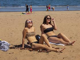 Summer is forecast to arrive in Edinburgh this week, with temperatures predicted to hit 21C on Saturday. Stock photo by SWNS of sunbathers at Portobello Beach.