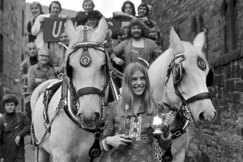 Edinburgh athlete Helen Golden received the Usher-Vaux Sportswoman of the Year Award for 1973.  She is beside a brewer's dray outside the firm's brewery.