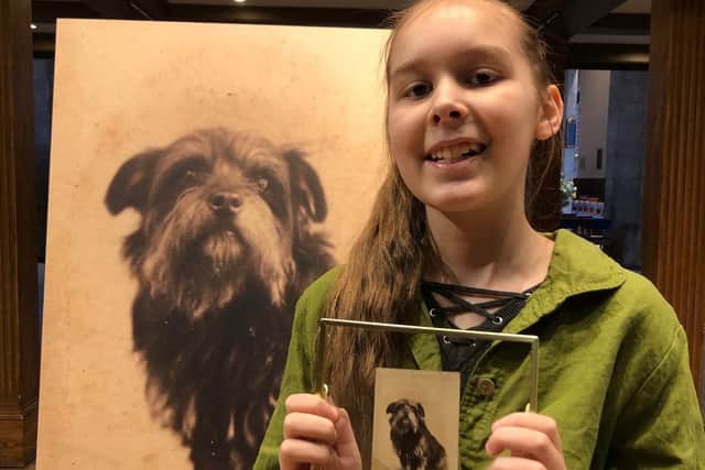 Friends of Dalry Cemetery volunteer Lani Knott with the photo of Greyfriars Bobby. Picture: Friends of Dalry Cemetery