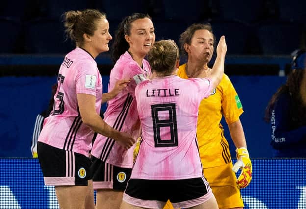 Scotland's Sophie Howard, Caroline Weir and Kim Little celebrate as Lee Alexander saves a penalty.