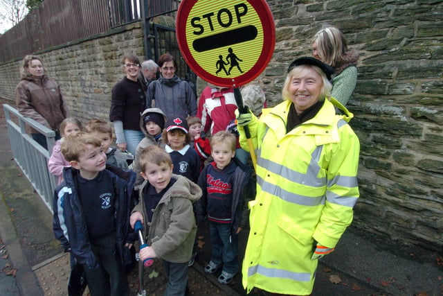 Lollipop lady Val Nethergate with children outside Clifford C of E School, Psalter Lane in 2008