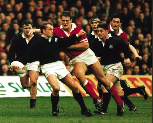 Gregor Townsend takes the brunt of the Welsh charge in the Scotland v Wales rugby game, 19 Feb 1996