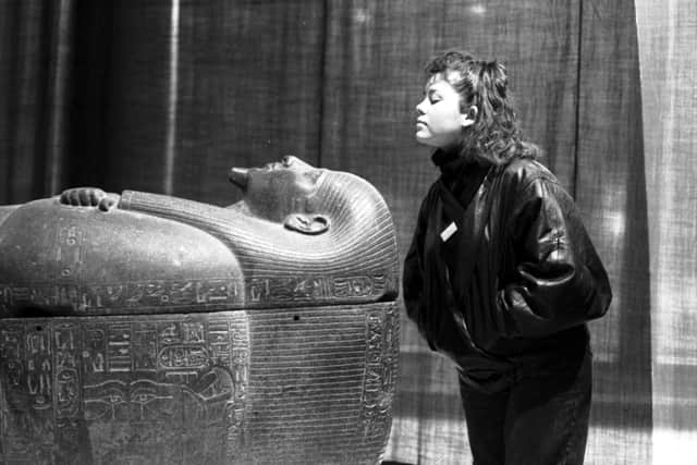 An unidentified female member of staff with the coffin of Psussenes , part of the Gold of the Pharaohs exhibition of ancient Egyptian artifacts at the City Art Gallery in Edinburgh, January 1988.