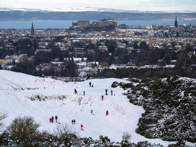 A view of Edinburgh Castle from The Braids with people sledging in the snow (Photo: Andrew O'Brien).