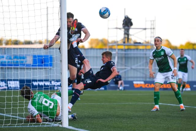 Christian Doidge, left, fails to get the ball over the line as Falkirk are able to clear after Ewan Henderson (not pictured) strikes both the bar and post. Picture: SNS