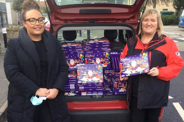 Gemma and Helen from Virgin Media with some of the selection boxes they gave to Dalkeith and District Community Council to pass onto the local community.