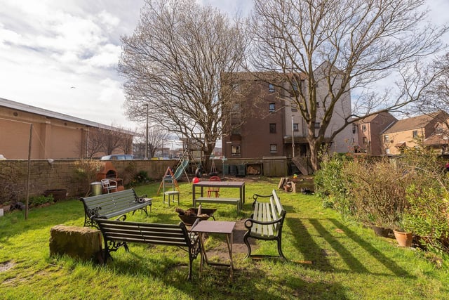 There is an enclosed rear garden which is shared with other residents in the block. It has a seating area, lawn and established trees. There is also unrestricted on-street parking outside the property.