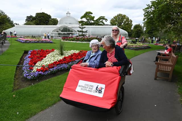 Mary McKell, 101, with daughter Eileen McAulay and trishaw pilot Shauna Brown in Glasgow Botanic Gardens. Picture: John Devlin