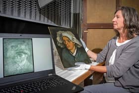 Senior conservator Lesley Stevenson viewing "Head of a Peasant Woman" alongside an X-ray image of a hidden self-portrait of Dutch painter Vincent Van Gogh in Edinburgh. (Photo by NEIL HANNA/National Galleries of Scotland/AFP via Getty Images)