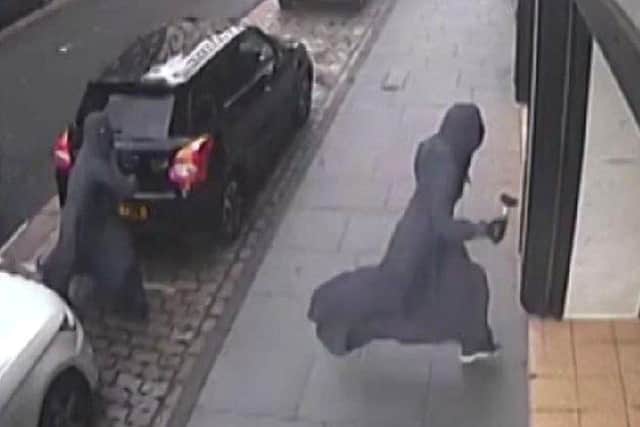 Armed raiders disguised as Muslim women raid the Dundee shop. (Pic: COPFS)