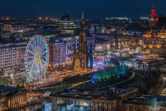 Scenic night cityscape of Edinburgh Princess Street Gardens during Christmas season.