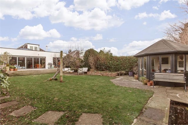 Externally, the home's spacious, private, and enviably south facing rear garden features a large lawn, a decked dining terrace, a patio and a delightful summerhouse. Excellent private parking is provided by an attached garage and a driveway.