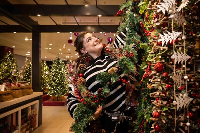 Restocking the garlands in the John Lewis Christmas Shop display.