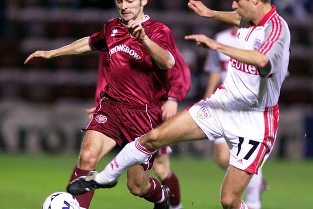 Hearts midfield ace Colin Cameron battles for possession with Stuttgart's Seitz. Picture: SNS