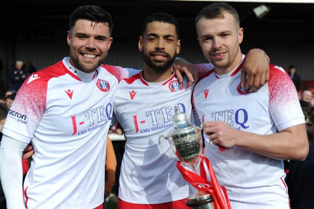 Sean Brown celebrates winning the Lowland league title with teammates Jordan Tapping and Kevin Waugh. Picture: Mark Brown / SFC
