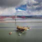 Aerial image of the Iron Lady barge with its cargo of a topside drilling platform for decommissioning being towed by Forth Ports tugs at the Forth Bridges into The Port of Rosyth on Sunday, April 11. Credit: Airbourne Lens