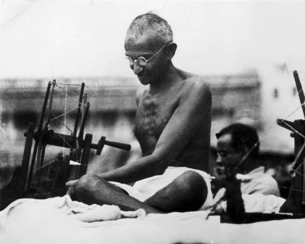 Mahatma Gandhi, seen at a spinning wheel during a 'Charlea' demonstration in Mirzapur, Uttar Pradesh, in 1925, campaigned for Indian independence from British rule (Picture: Hulton Archive/Getty Images)