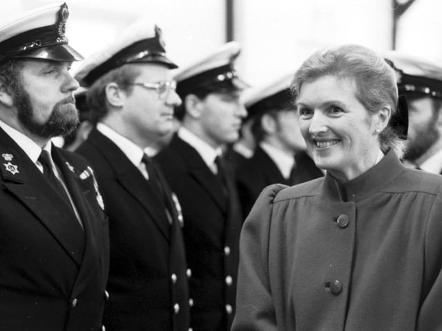 Anne Heseltine, wife of Defence Secretary Michael Heseltine, with some of the crew of HMS Edinburgh, a Royal Navy Type 42 destroyer, commissioned at Leith docks in December 1985.