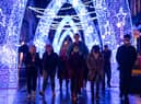 Shoppers walk through Christmas lights on South Molton Street, in central London.