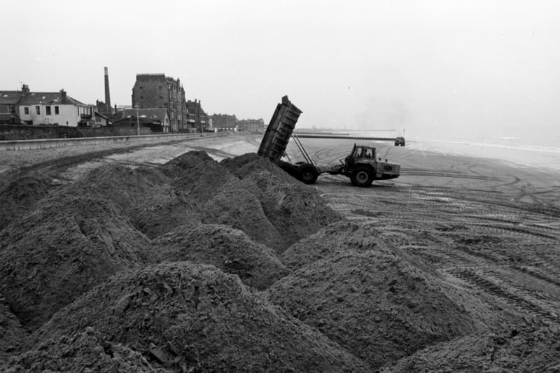 A lorry dumps new sand onto Portobello beach, January 1980.